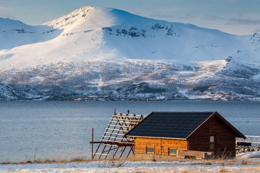 Isolated home and beach on a snowy lake