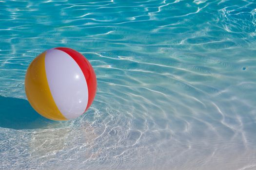 Inflatable colorful ball floating in a swimming pool