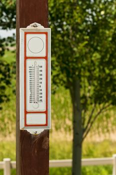 Vintage thermometer showing 75 degrees fahrenheit and 24 degrees Celsius