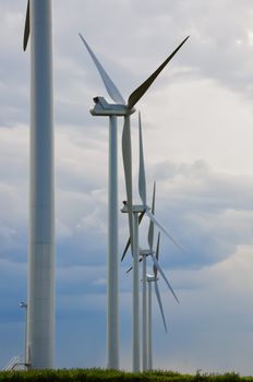 Tall wind generators making electriciy from renewable wind power in central Colorado, USA.