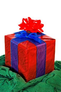 Christmas present in red and blue on green cloth