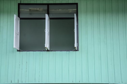Windows with green wooden wall