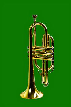 Brass trumpet isolated against a green background