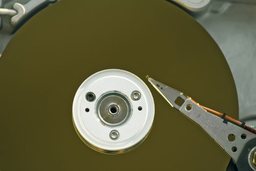 Inside of a desktop computer hard drive showing the platters and read-write arm and head.