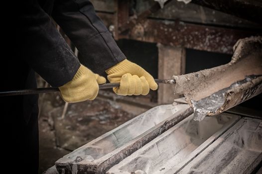 Industrial worker in metal melting factory