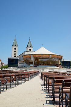 MEDUGORJE, BOSNIA AND HERZEGOVINA - JULY 4, 2016: Benches and altar behind the parish church of St. James, the shrine of Our Lady of Medugorje