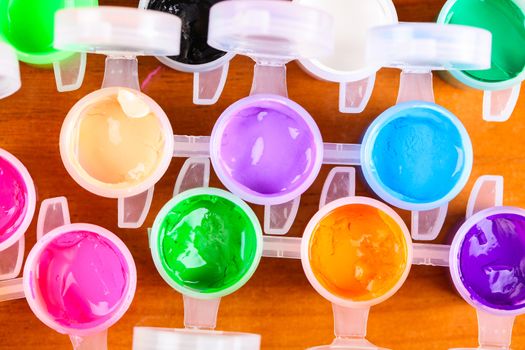 set of colorful paints close-up on wooden background