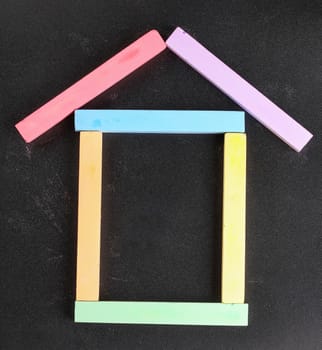 set of colored crayons on a black background