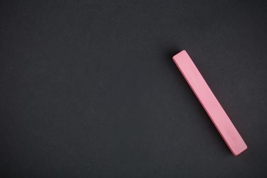 red chalk close-up against the black background