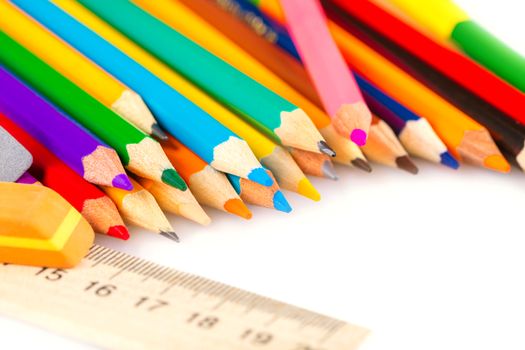 set of colored pencils with a ruler and an eraser