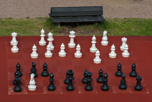 White and black chess pieces of large size for outdoor games.