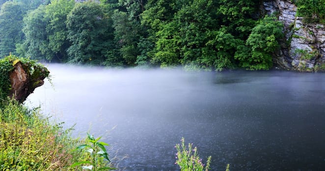 View on foggy river during rain.