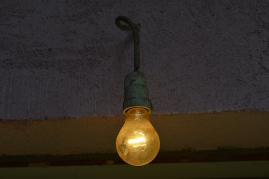 Old dusty light bulb on a cable