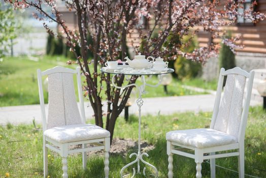 wedding decor chairs with a table, cups, teapot