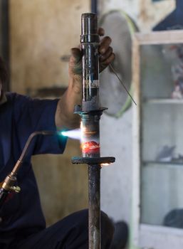 Welders were repairing cutting Shock absorbers of a car in workshop