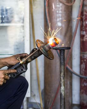 Welders were repairing cutting Shock absorbers of a car in workshop