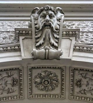 Close up on a head sculpture on a building in Vienna, Austria