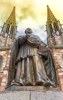 Statue of Charles-Emile Freppel in front of Saints-Pierre-et-Paul-Church in Obernai by day, France