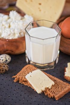 still life with dairy products as milk, cheese cottage cheese eggs and bread