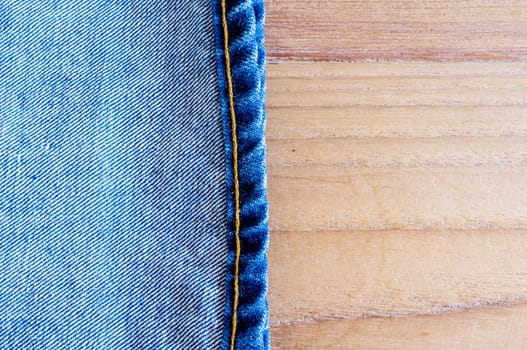 fold legs vintage jeans  on wooden background.