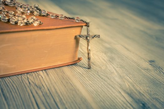 vintage rosary beads on old books,close up.