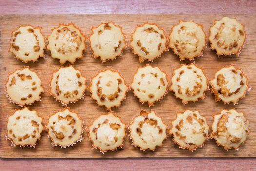 Top view of eighteen freshly baked muffins stuffed with boiled condensed milk