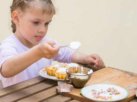 Girl puts focus on confectionery glaze Easter cupcakes
