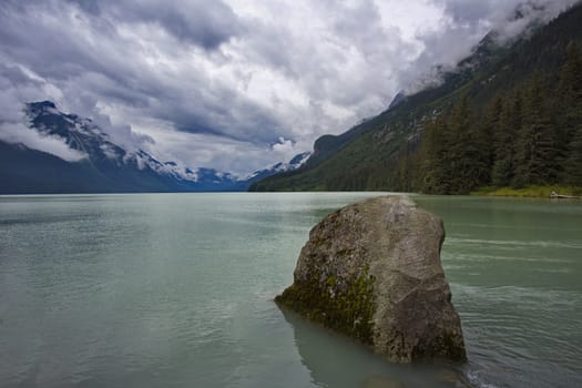 Rock in foreground of serene sky above Chilkoot Lake.  Location is Haines, Alaska, United States.  Horizontal image with copy space.  Excellent salmon fishing in this Southeast Alaska area. 