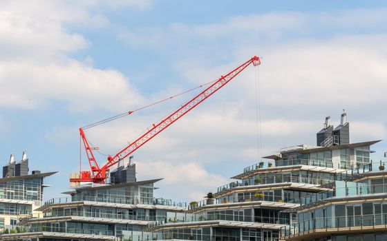 Red crane and modern apartment buildings
