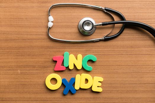 zinc oxide colorful word with stethoscope on wooden background
