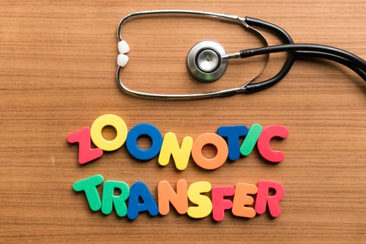 zoonotic transfer colorful word with stethoscope on wooden background