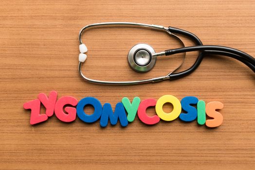 zygomycosis colorful word with stethoscope on wooden background
