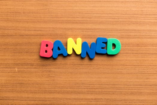 banned colorful word on the wooden background