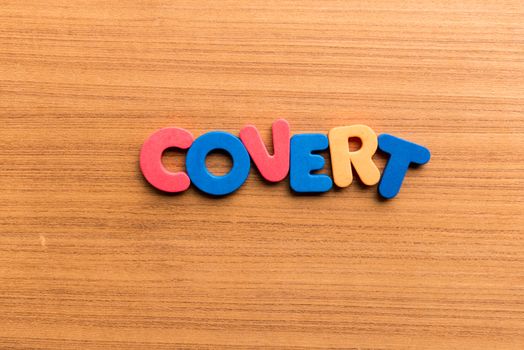 covert colorful word on the wooden background