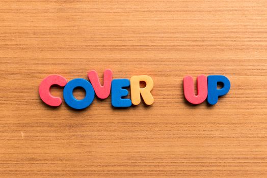 cover up colorful word on the wooden background