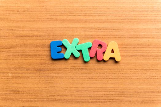 extra colorful word on the wooden background