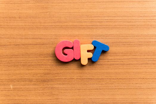 gift colorful word on the wooden background