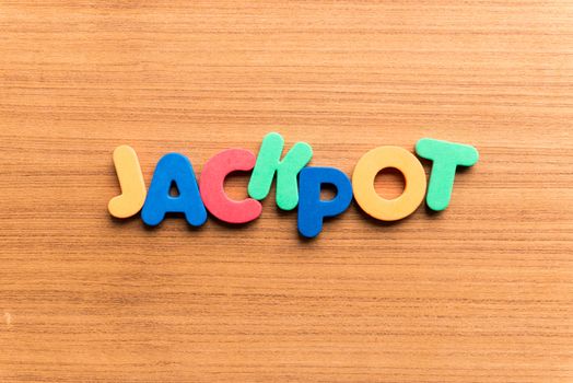 jackpot colorful word on the wooden background