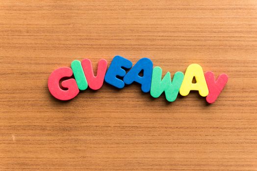giveaway colorful word on the wooden background