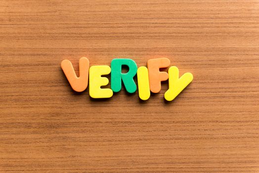 verify colorful word on the wooden background