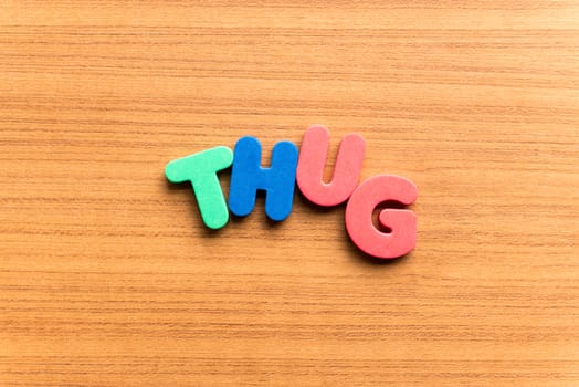 thug colorful word on the wooden background