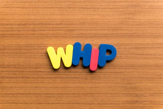 whip colorful word on the wooden background