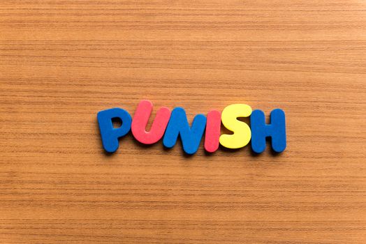 punish colorful word on the wooden background