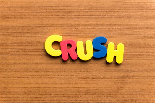 crush colorful word on the wooden background