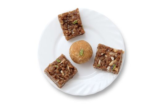 Indian sweets on a plate isolated over white