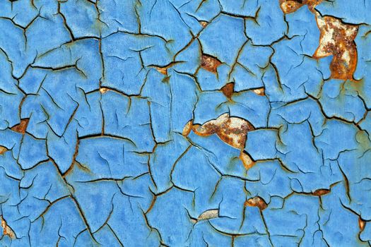 Close-up of peeling paint and rust on a wall