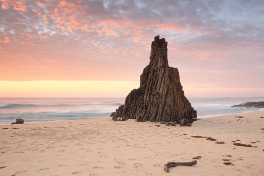 Beach seascape from Meringo, Eurobodalla National park, with magnificent shaped sea stack pointing to that awesome sunrise sky
