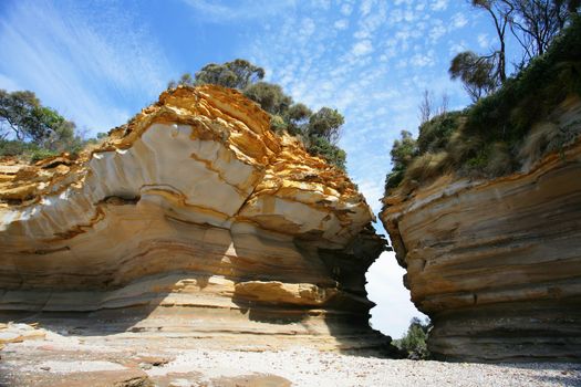 Beautiful textures and patterned sandstone, weathered and worn down by the ocean, weather and elements over time, eventually creating a cracked chasm and splitting into two.  Parts of the coast here show evidence of glacial weathering.  Yes the area was frozen at one stage before the earth warmed up and the ice melted.
