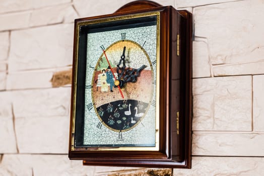 wall clock hanging on the white stone wall