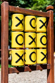 Tic-tac-toe game on the playground in sunny weather